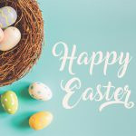 A nest filled with colorful Easter eggs is on the left side of the image, with three more eggs outside the nest. "Happy Easter" is written in white cursive text on the right side against a light blue background.