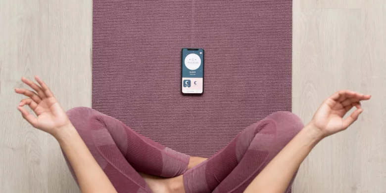 fitness woman doing yoga with a mobile Meditation app