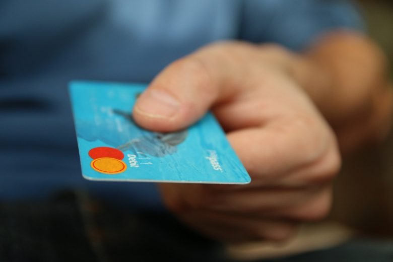 Person Holding Debit Card, No Fee Debit Card