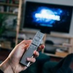 person holding gray remote control, Television Commercial Company