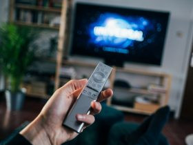 person holding gray remote control, Television Commercial Company