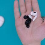 white and black earbuds on persons hand, THESPARKSHOP.IN:PRODUCT/WIRELESS-EARBUDS-BLUETOOTH-5-0-8D-STEREO-SOUND-HI-FI