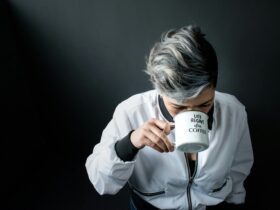 woman holding mug in drinking gesture, Know-The-Causes-Of-White-Hair-And-Easy-Ways-To-Prevent-It-Naturally