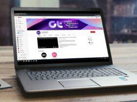 A laptop computer sitting on top of a wooden table