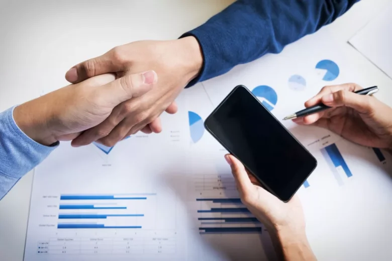 business handshake of two men demonstrating their agreement to sign agreement or contract between their