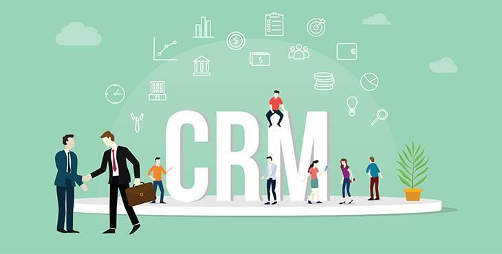 Illustration of people interacting around large "CRM" letters on a platform. Two men in suits shake hands on the left, while others talk, use laptops, and stand on the letters. Various icons related to finance and communication float above them.