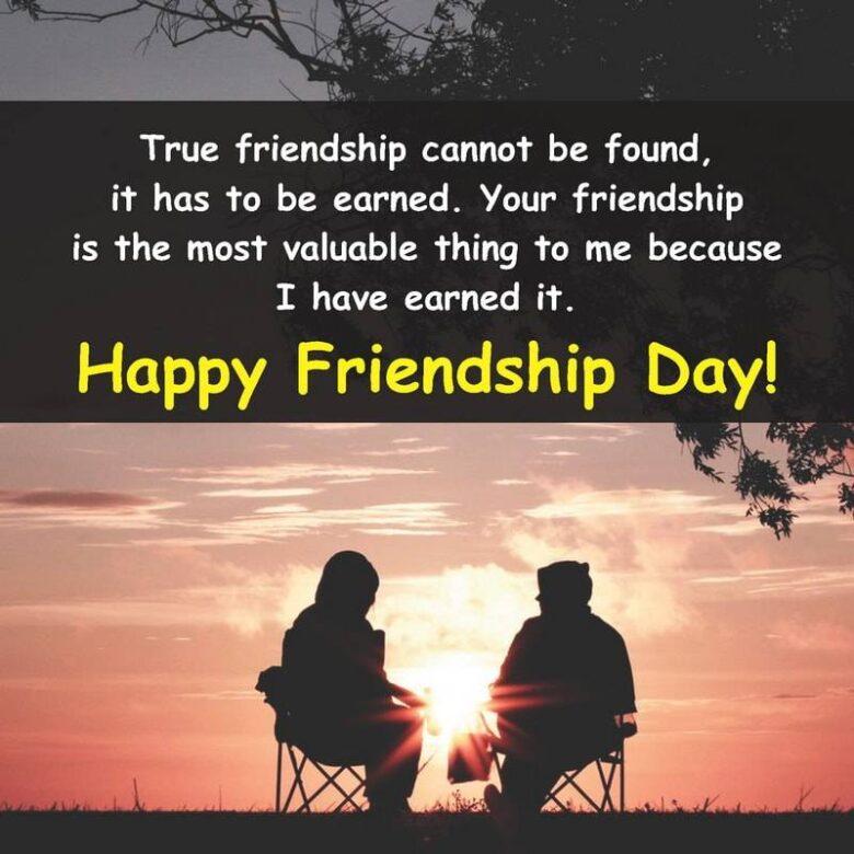 A scenic sunset background with two people sitting in folding chairs, facing each other. Text over the image reads: "True friendship cannot be found, it has to be earned. Your friendship is the most valuable thing to me because I have earned it. Happy Friendship Day!.