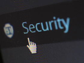Close-up image of a computer screen with the word "Security" highlighted in light blue and a cursor icon resembling a pointing hand positioned nearby.