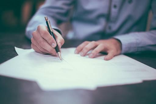 business man write on paper with premium pen