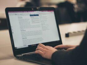 person typing on laptop computer, content marketing