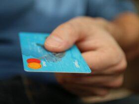 Person Holding Debit Card, No Fee Debit Card