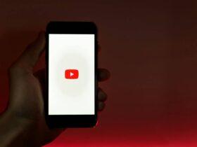 Hand Holding Smartphone with Internet Access to YouTube, youtube setting