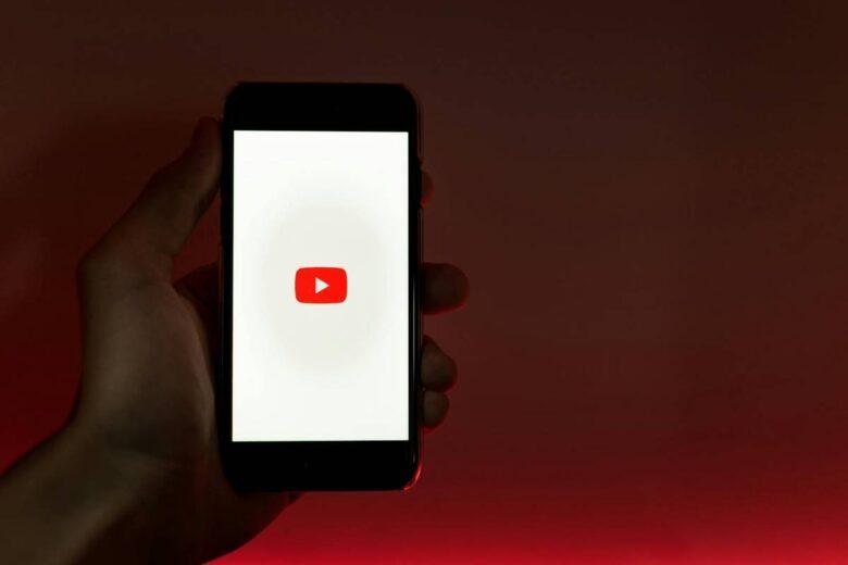 Hand Holding Smartphone with Internet Access to YouTube, youtube setting