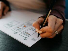 person writing on white paper