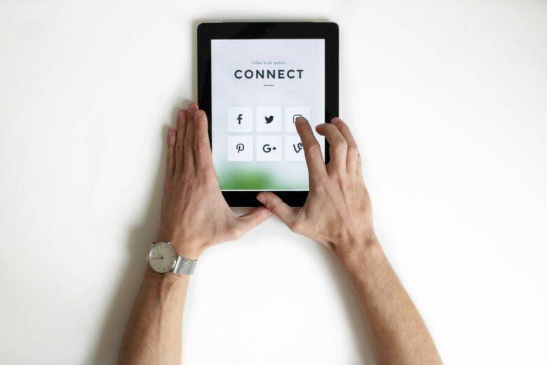 person using black iPad Erome digital platform
