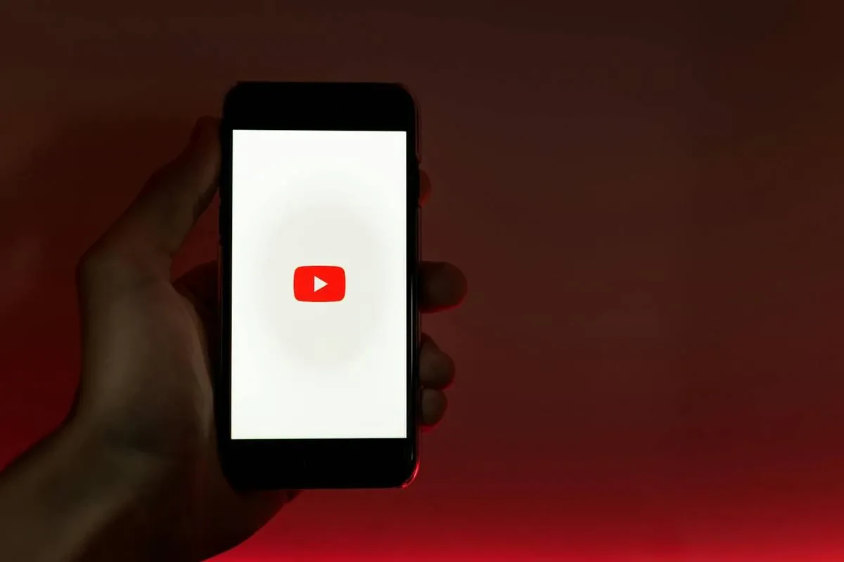 Hand Holding Smartphone with Internet Access to YouTube, youtube setting