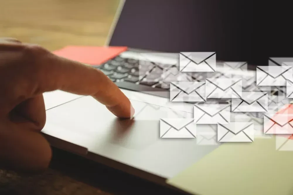 hand tounching laptop and many envelopes, Best Email Marketing Courses For Business