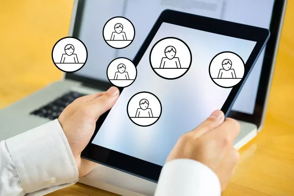 hands holding a tablet with icons relate to employee engagement platform