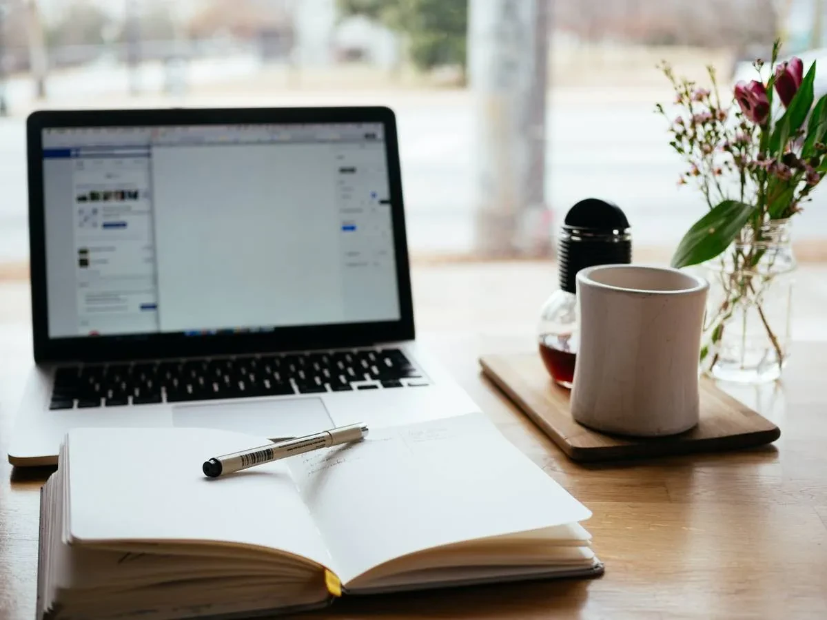MacBook Pro near white open book, Content Marketing