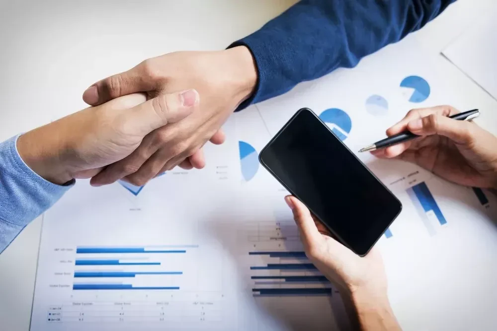 business handshake of two men demonstrating their agreement to sign agreement or contract between their