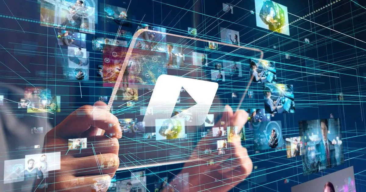 Hands holding a transparent tablet amidst a backdrop of floating digital images and graphics, suggesting media consumption, technology, and connectivity.