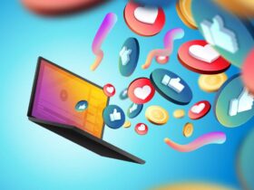 An open laptop with colorful icons such as thumbs up, hearts, and dollar signs emerging from the screen, symbolizing social media engagement and online interactions, set against a gradient blue background.