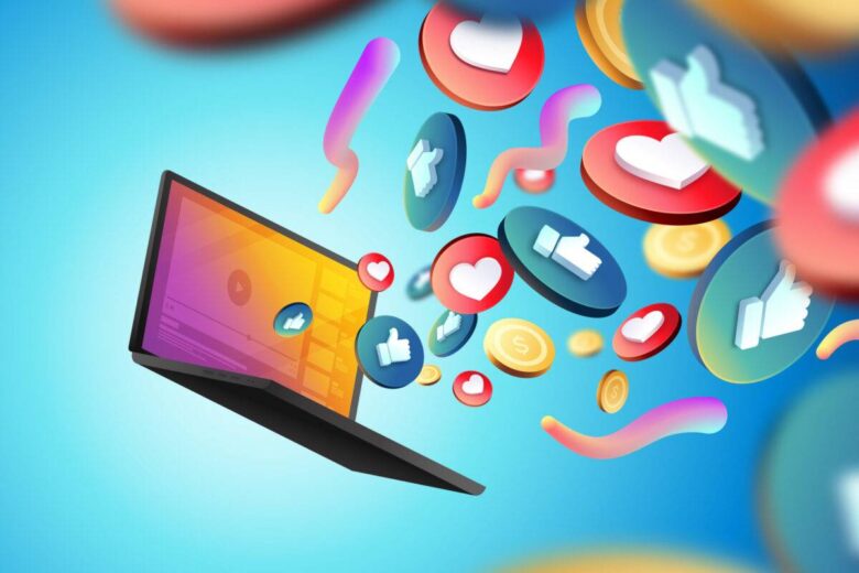 An open laptop with colorful icons such as thumbs up, hearts, and dollar signs emerging from the screen, symbolizing social media engagement and online interactions, set against a gradient blue background.