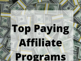 A large pile of U.S. dollar bills, both loose and in bundled stacks, serves as the background for bold black text that reads "Top Paying Affiliate Programs" within a semi-transparent white square.