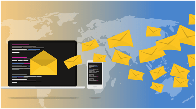 A laptop and smartphone display open yellow envelopes, symbolizing emails being sent. The background features a gradient world map, transitioning from beige on the left to blue on the right, with multiple envelopes flying towards the right side of the image.