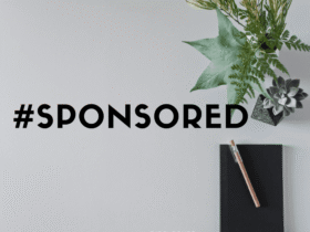 A flat lay image featuring a black notebook with a wooden pencil resting on it, next to a small potted succulent and some greenery. The main focus is the bold text reading "#SPONSORED" in the center. The word "DISCLOSURE" is faintly visible at the bottom.