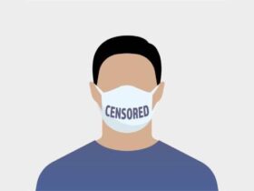 Illustration of a person wearing a face mask labeled "CENSORED" on the front. The figure is depicted from the shoulders up, and the background is light gray. The person has short, dark hair and is wearing a blue shirt.