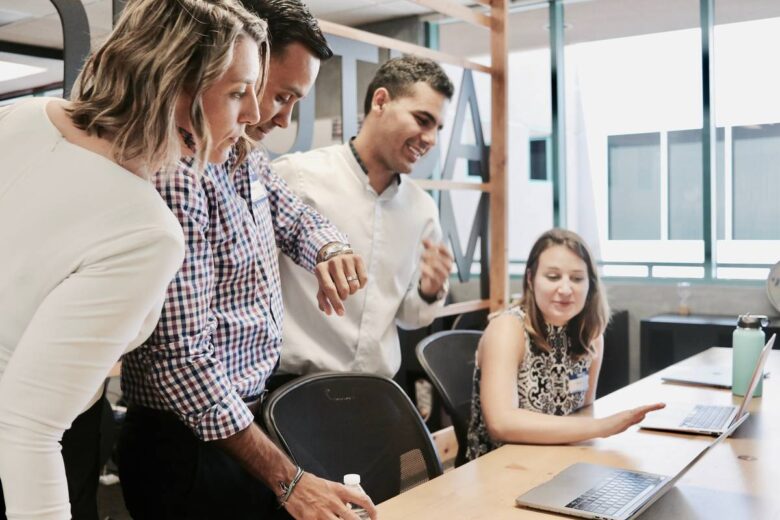 woman sitting and discussing with colleagues at office table