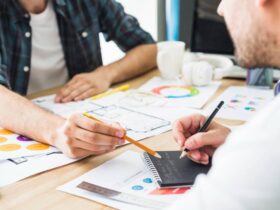 businessman dictating notes to his colleague in office