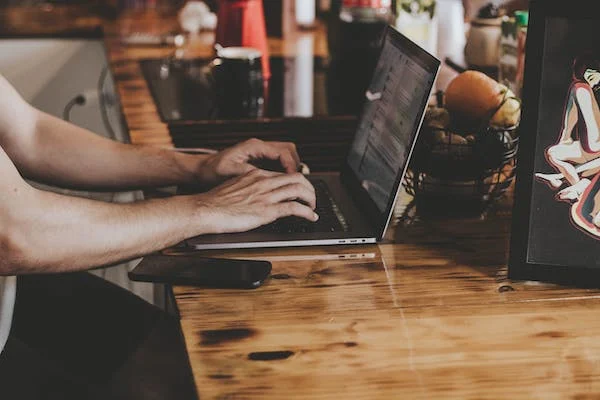 blog typing on laptop