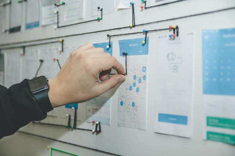 person working on blue and white paper on board,Stakeholder Mapping